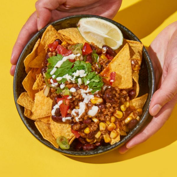 Vegan Chili Instant Mince by Sunflower Family served with tortilla chips, salsa, and fresh coriander.